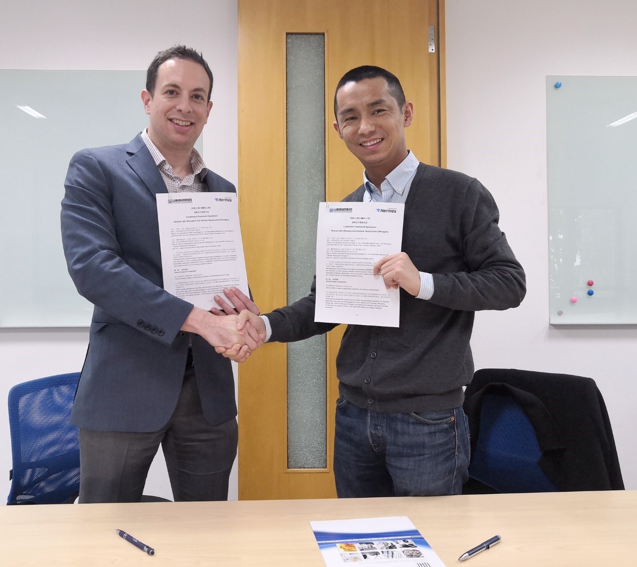 QAI and Hansecontrol shaking hands on Signed Agreement