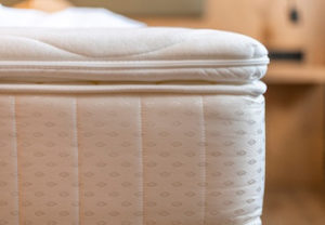 Close up of mattress edge showing layered construction and surface materials