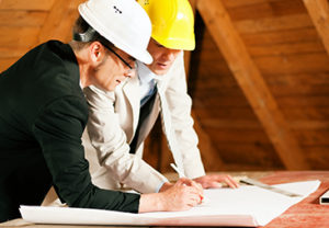 Construction professionals reviewing plans for residential building code compliance