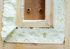 Spray Polyurethane Foam Insulation Cross Section Close view of spray polyurethane foam insulation installed within a wood assembly
