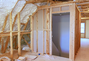 Spray foam insulation installed along roof framing in unfinished attic